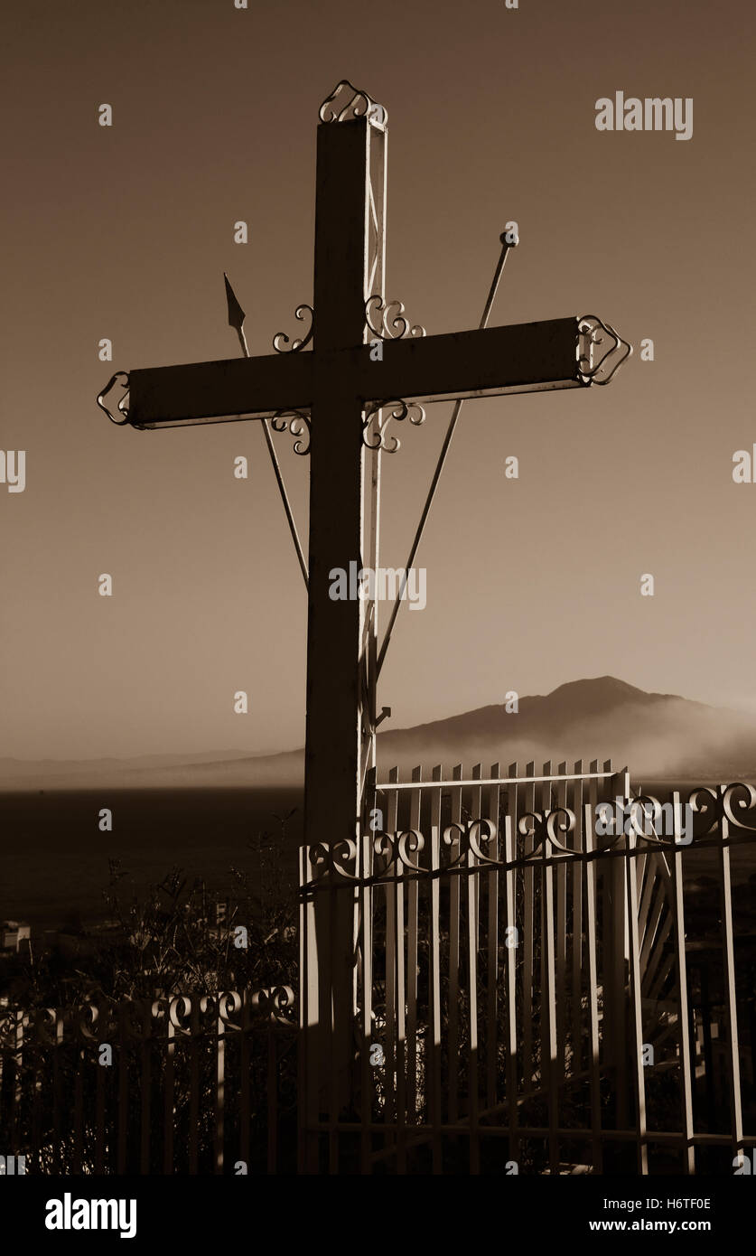 Segno della Croce sul Monte Vesuvio visto in background è avvolta nella nebbia di ringhiere metalliche circostanti la protezione incrociata seppia. Foto Stock