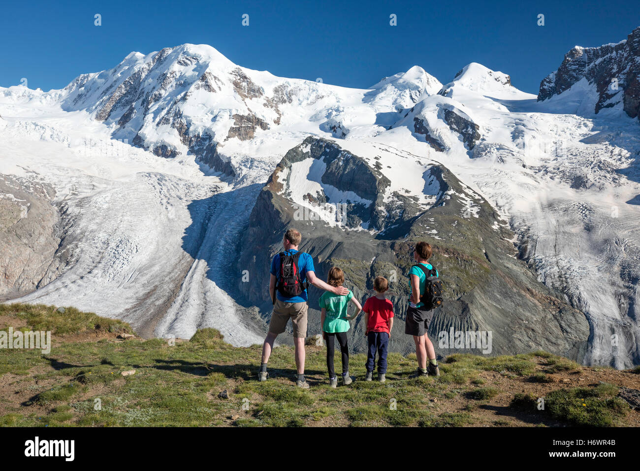 Escursionismo famiglia guardando al Monte Rosa dal Gornergrat. Zermatt, Pennine, Vallese, Svizzera. Foto Stock