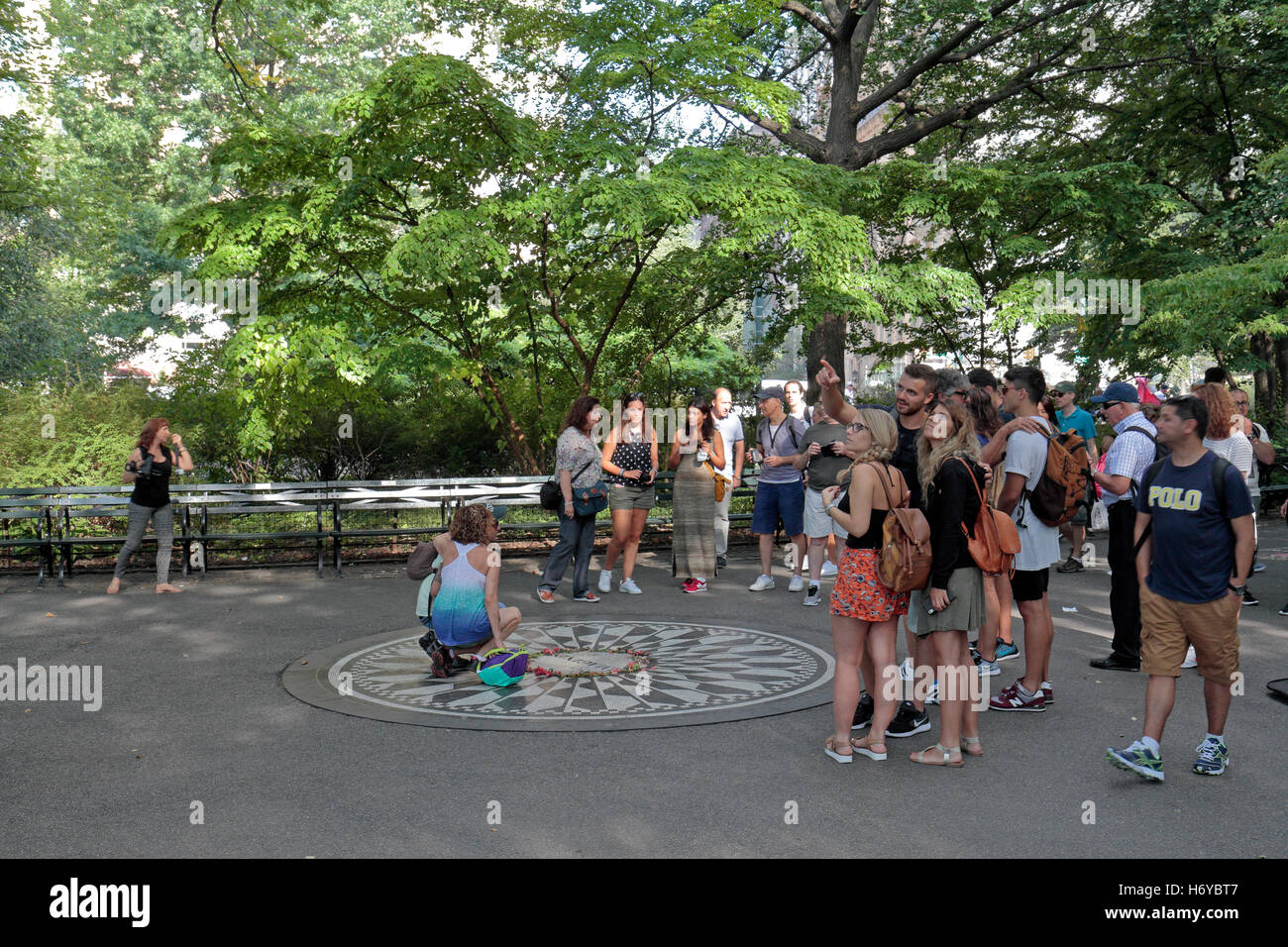 Una folla di turisti intorno all'immaginare il mosaico in Strawberry Fields, al Central Park di New York. Foto Stock