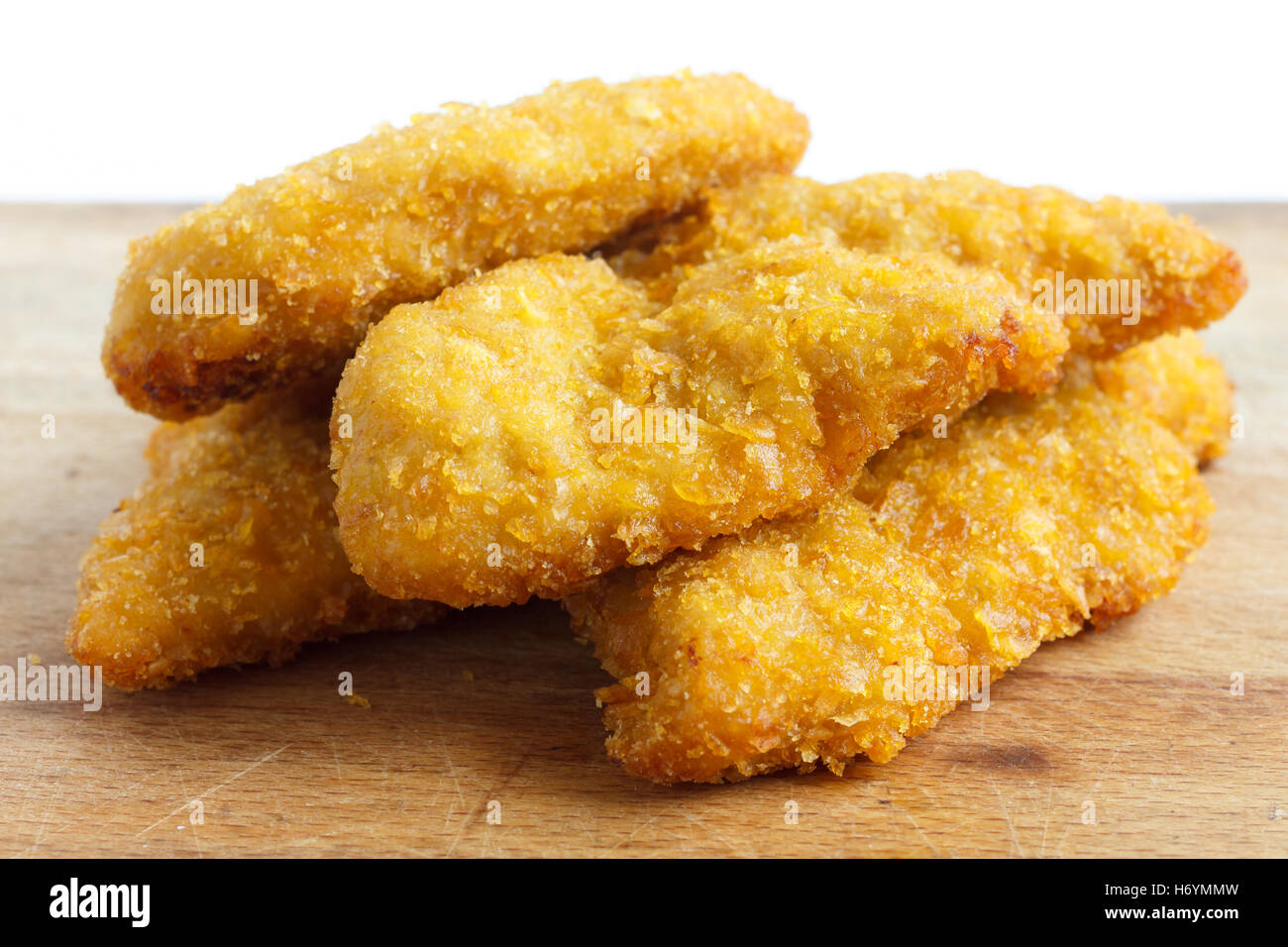 Golden Fried Chicken strisce sul pannello di legno. Foto Stock