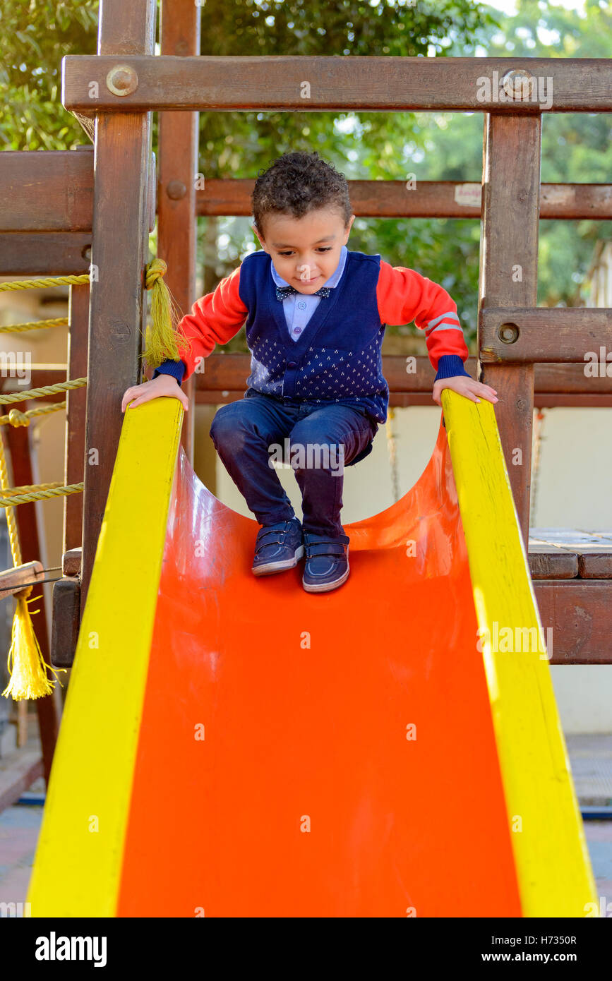 Piccolo felice giovani bambini che giocano al parco per bambini Foto Stock