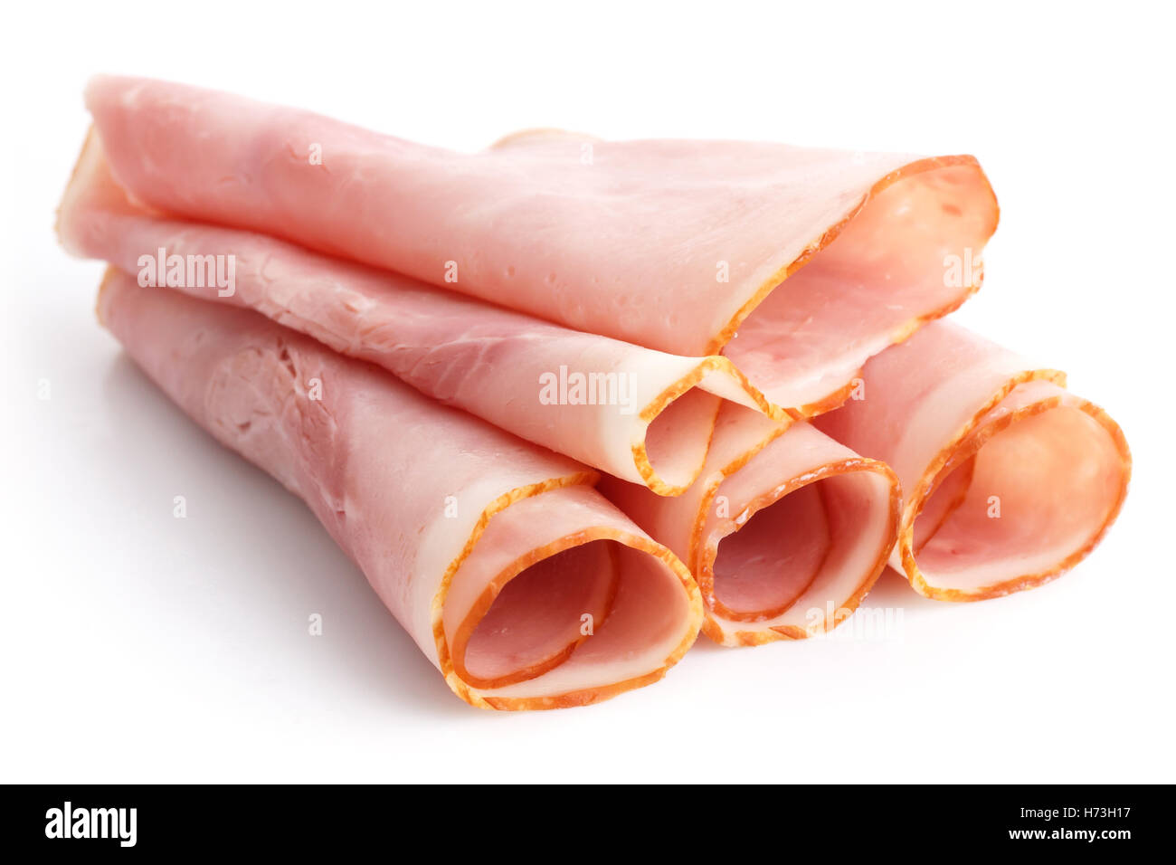 Premio fette di prosciutto disposti su bianco. Foto Stock