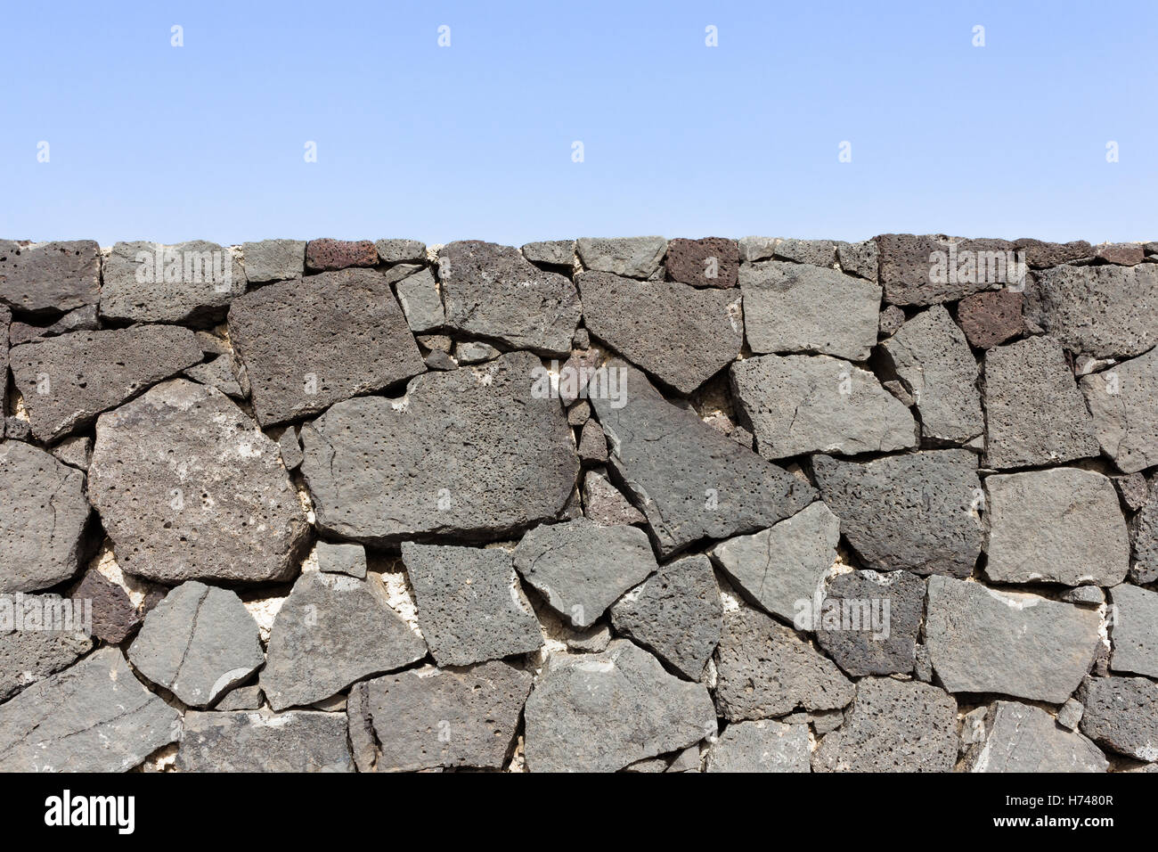 Muro di confine in pietra lavica Foto Stock