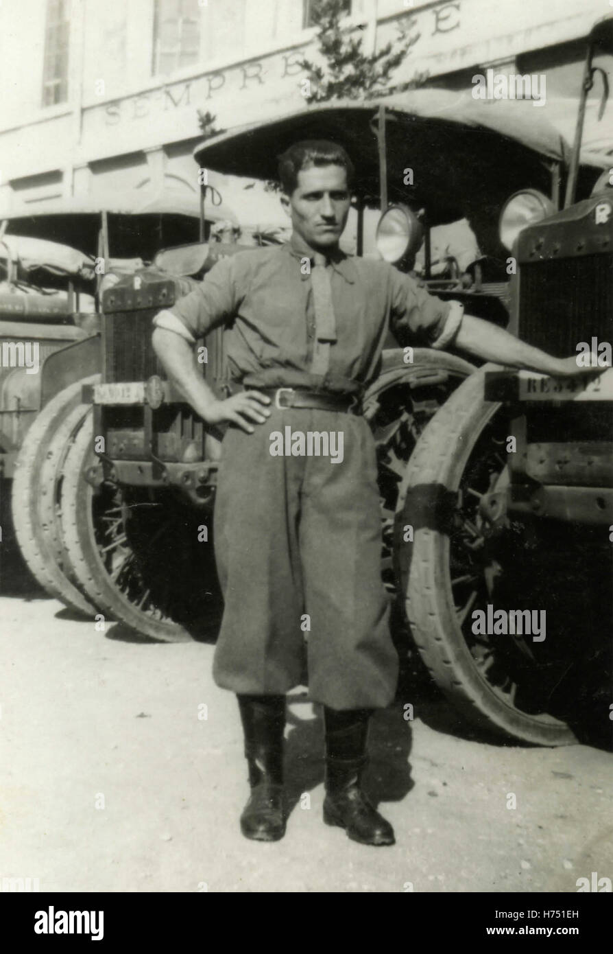 Soldato del Regio esercito italiano al fianco di veicoli Foto Stock