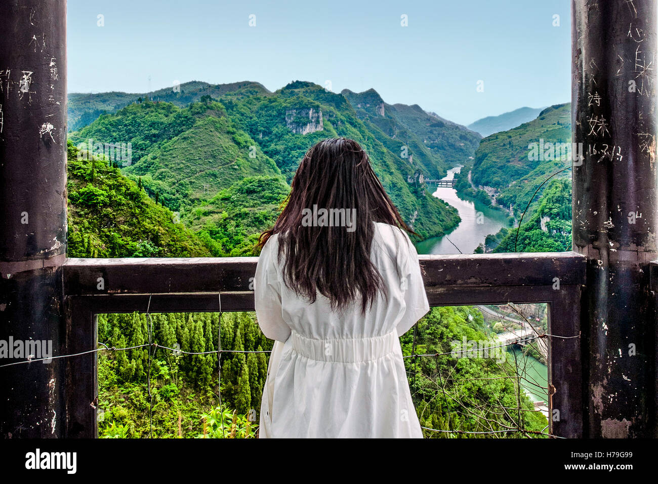 Bambina guarda al Fiume Wuyang dal tempio alla sommità della collina che si affaccia sul villaggio Zhenyuan (Guizhou, Cina) Foto Stock