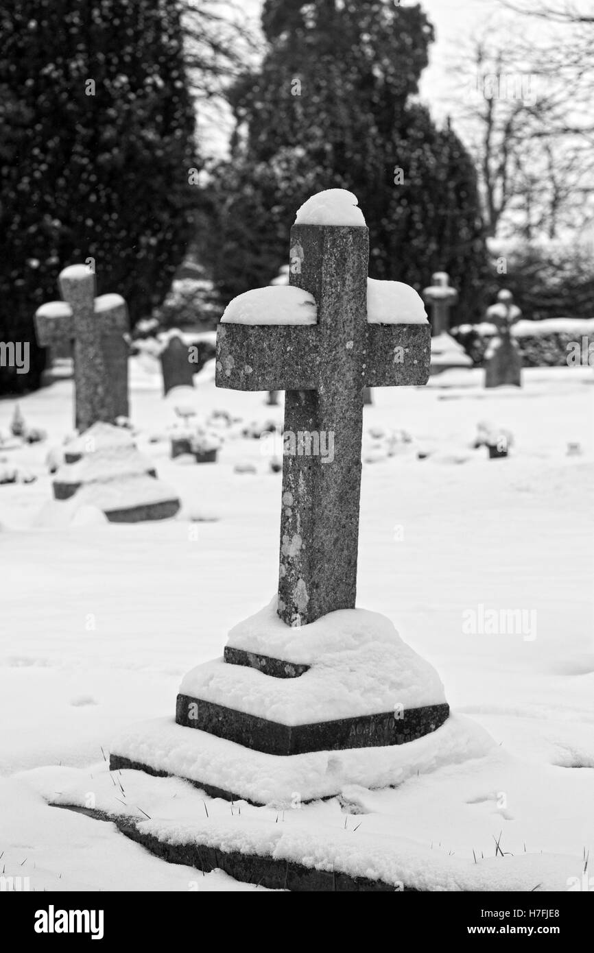 Coperta di neve attraversa in un cimitero. Foto Stock