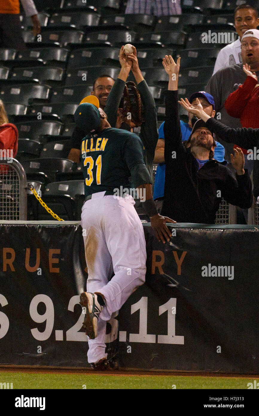 Settembre 21, 2011; Oakland, CA, Stati Uniti d'America; un Oakland atletica fan afferra un fallo sfera nella parte anteriore del primo baseman Brandon Allen (31) durante l'ottavo inning contro il Texas Rangers a O.co Coliseum. Texas sconfitto Oakland 3-2. Foto Stock