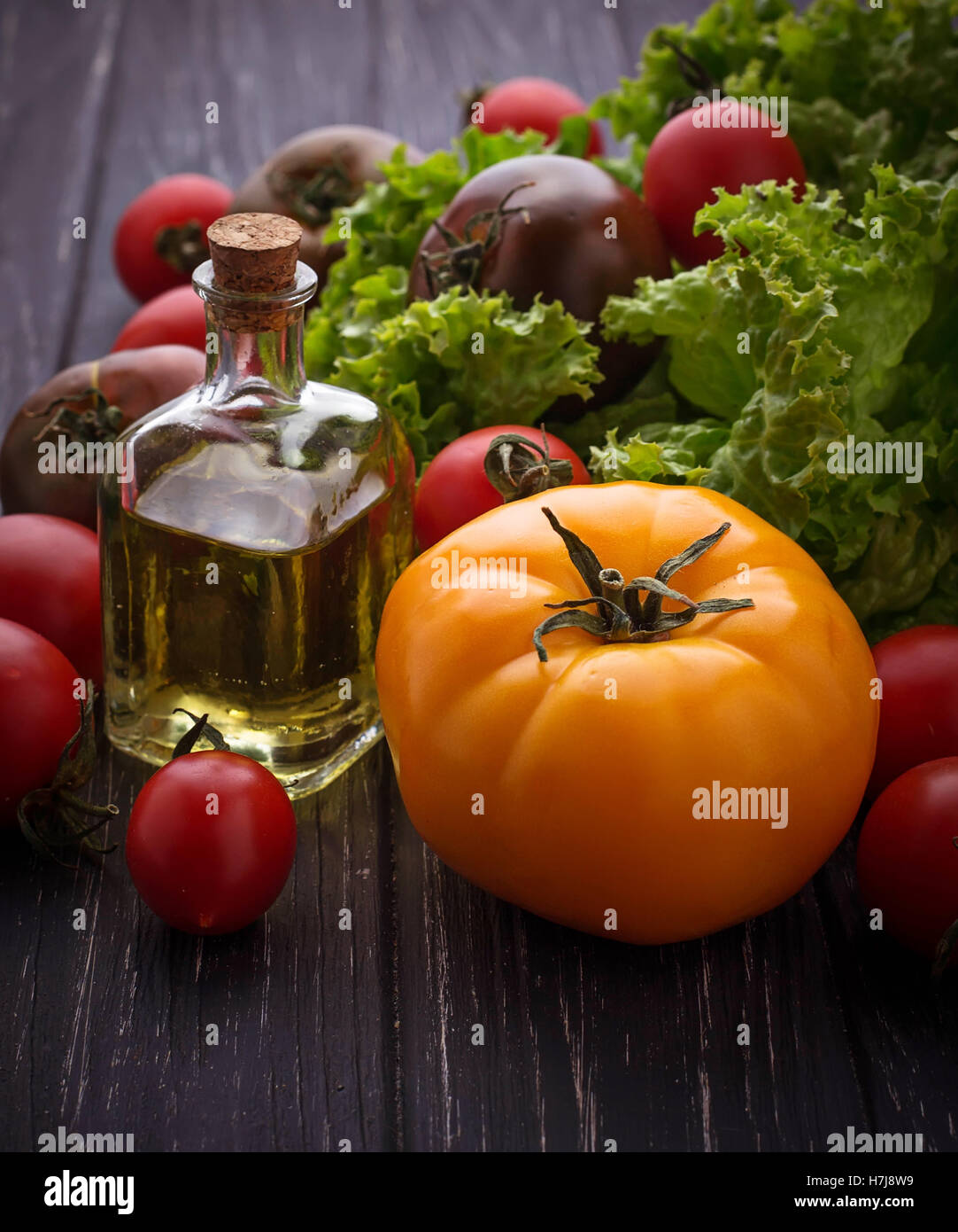 Pomodori colorati su sfondo nero. Messa a fuoco selettiva Foto Stock