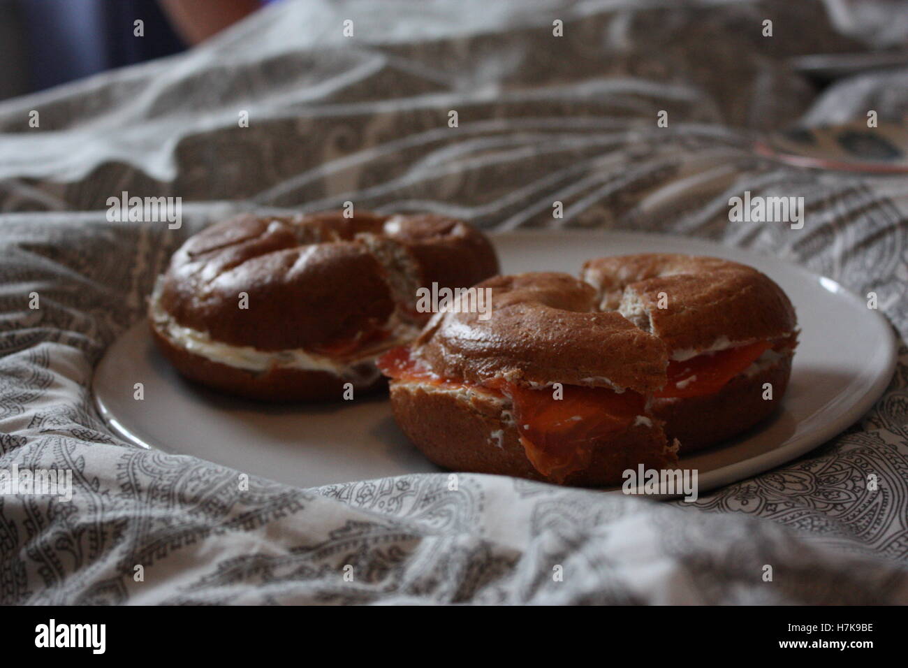 Salmone affumicato e crema di formaggio bagel su una piastra sul letto Foto Stock