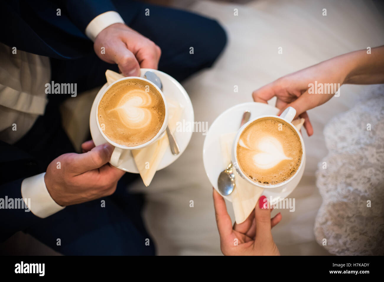 Paio di persone che trattengono le tazze con caffe con fine arte nel cafe Foto Stock