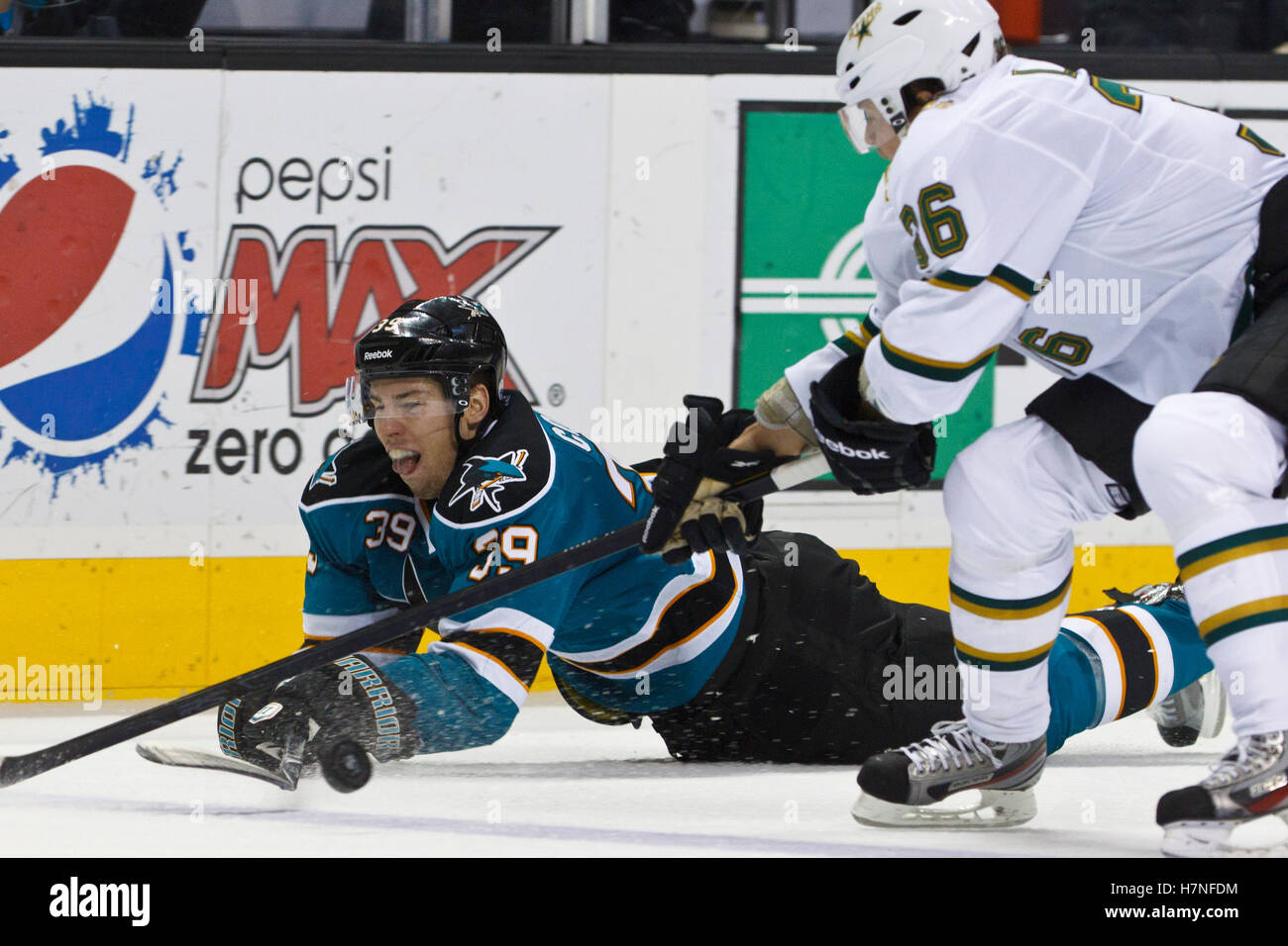 8 dicembre, 2011; San Jose, CA, Stati Uniti d'America; San Jose Sharks center Logan Couture (39) immersioni per un puck allentata nella parte anteriore del Dallas Stars defenceman Philip Larsen (36) durante il terzo periodo a HP Pavilion. San Jose sconfitto Dallas 5-2. Foto Stock