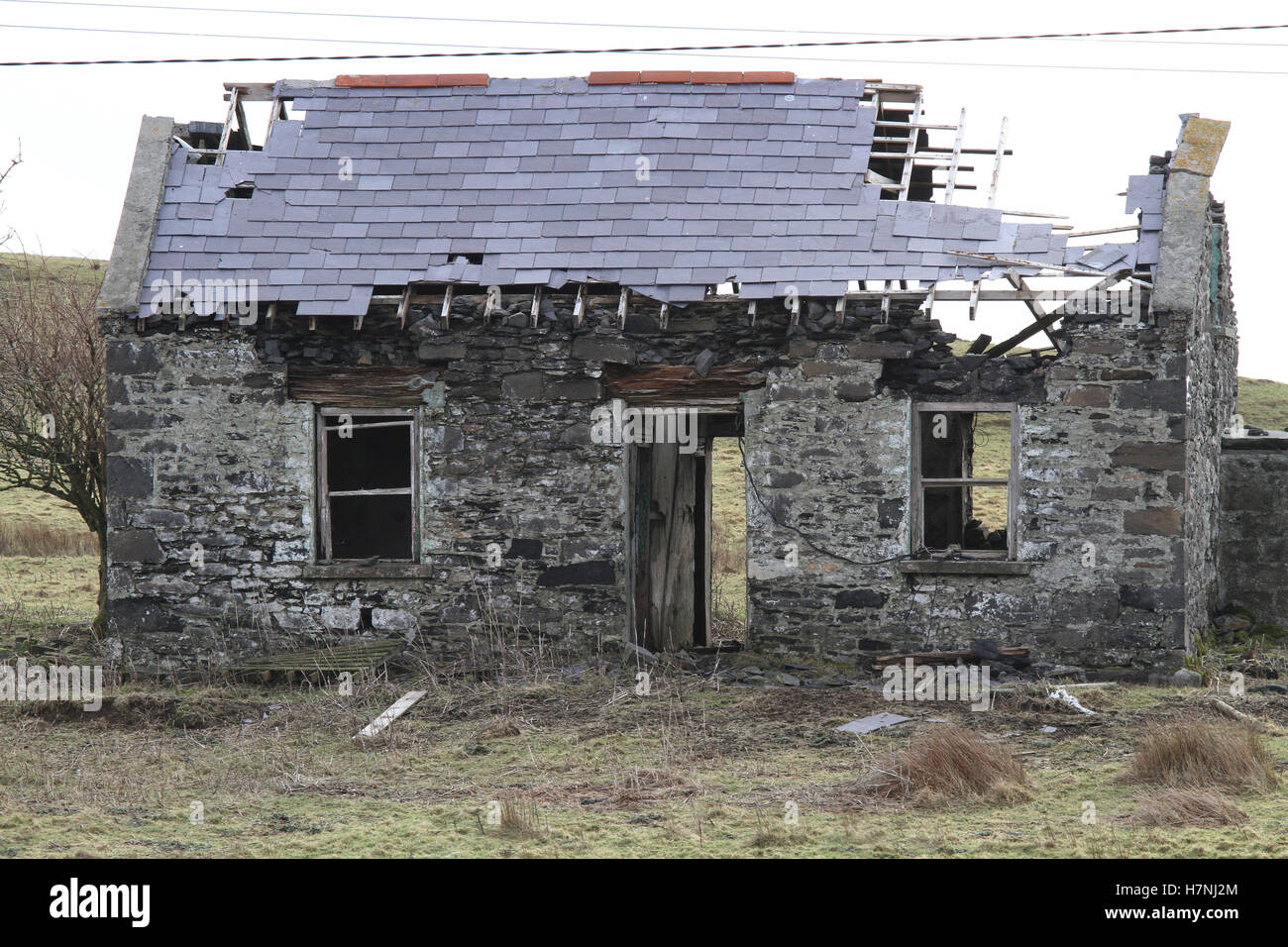 In rovina, vecchio casolare in pietra con mura di pietra derelict in rovina con tetto di ardesia danneggiato, abbandonato in Irlanda, vicino a St John's Point, County Donegal, Foto Stock