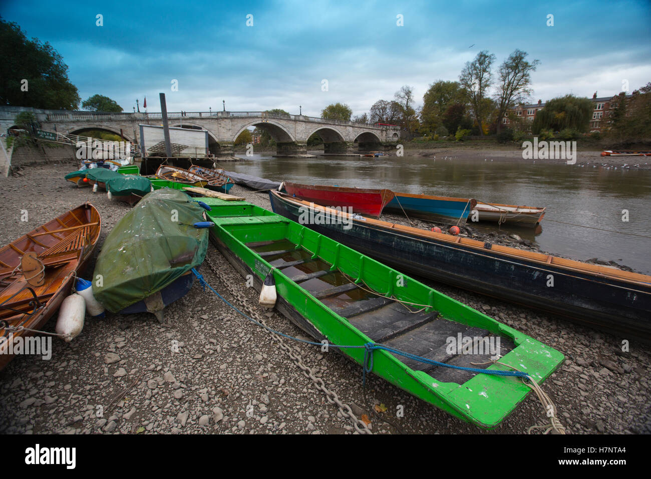 Richmond Upon Thames, barche giacenti lungo il letto del fiume in superficie durante la bassa marea sul grigio di un pomeriggio autunnale, London Borough of Richmond, Esterno Londra, Regno Unito Foto Stock