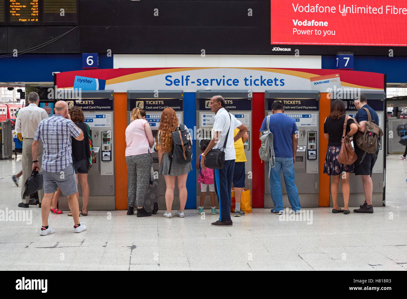 Passeggeri presso i distributori automatici di biglietti self-service presso la stazione ferroviaria di London Waterloo, Londra Inghilterra Regno Unito Regno Unito Foto Stock
