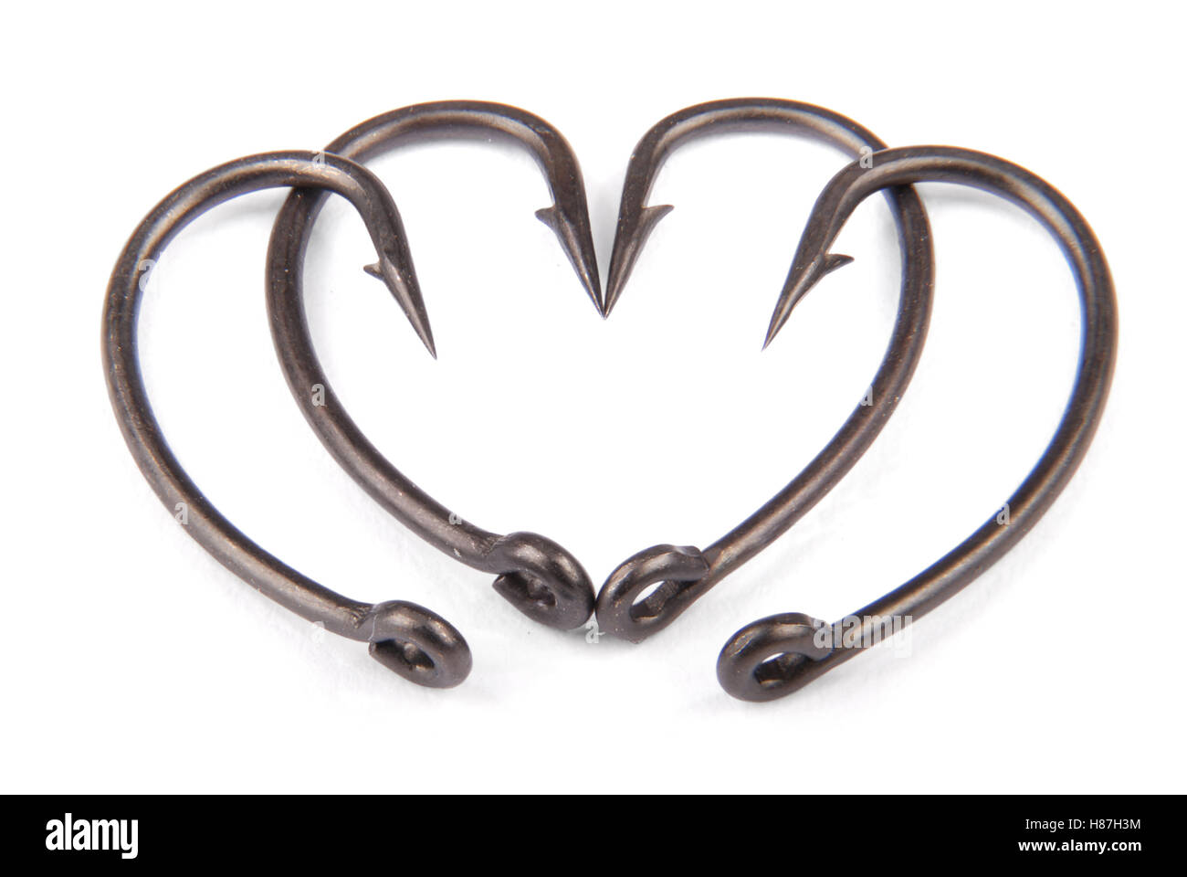 Quattro fishhook redatto in forma di cuore isolato su bianco backround. Tracciato di ritaglio Foto Stock