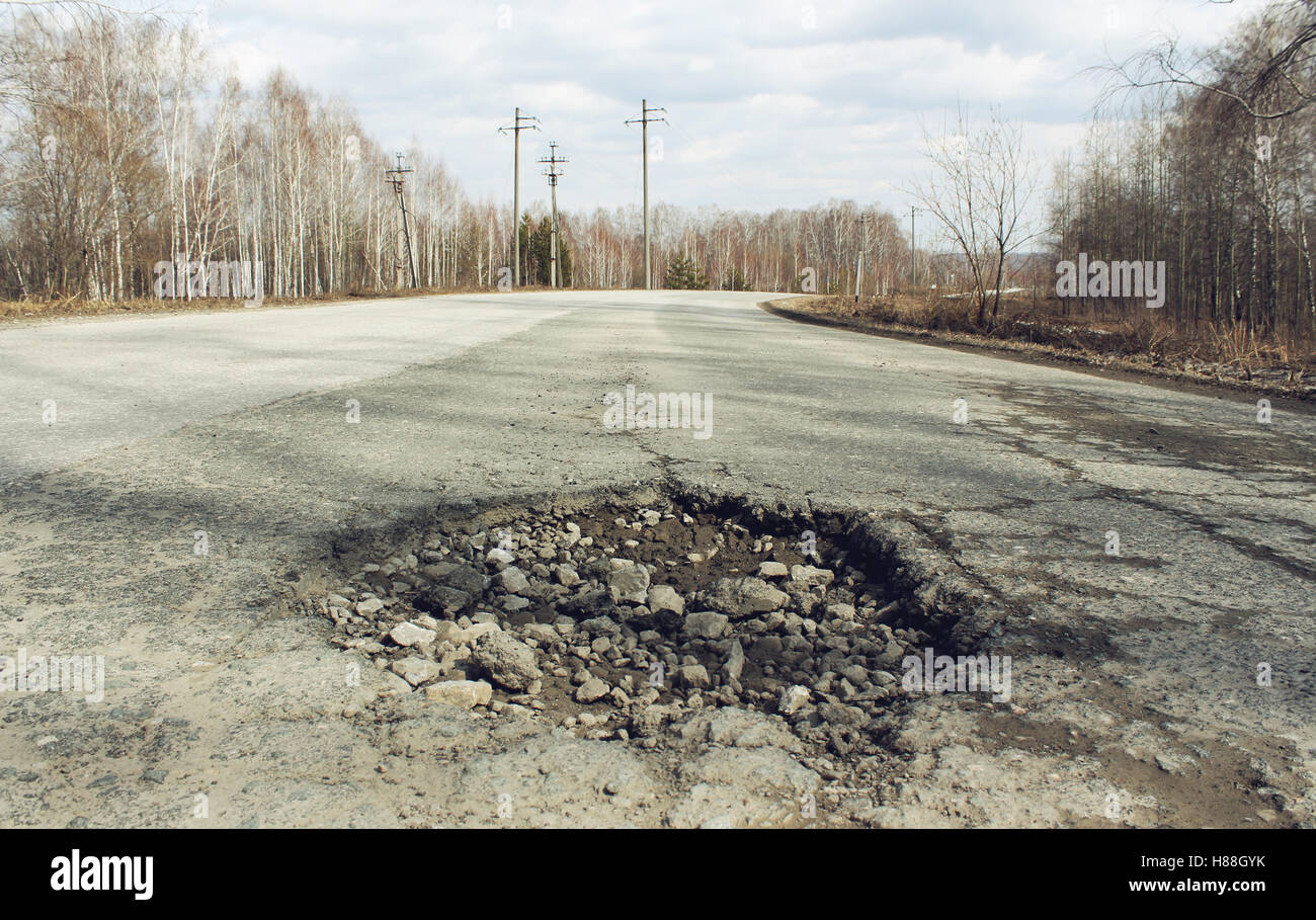 Fossa di grandi dimensioni sulla strada suburbana Foto Stock