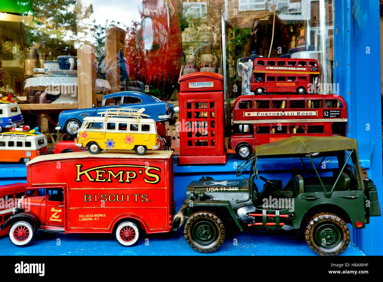 Molti vecchi veicoli giocattolo da collezione in colori brillanti in esposizione in un negozio di vetrine. Mercato di Portobello Road. Londra, Inghilterra, Regno Unito, Europa. Primo piano Foto Stock