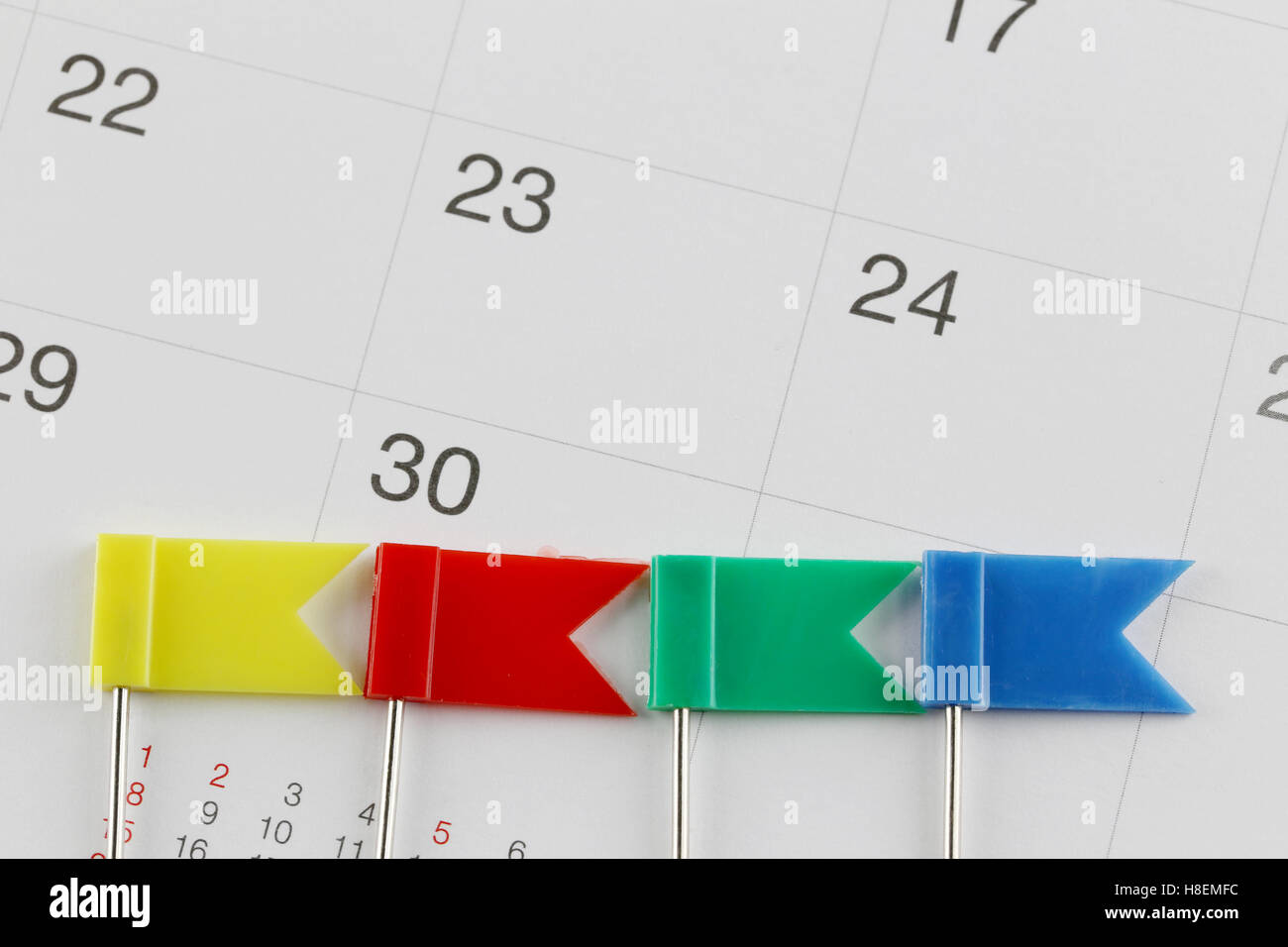Perni al posto sul calendario accanto al numero di trenta nel concetto di business data e ora. Foto Stock