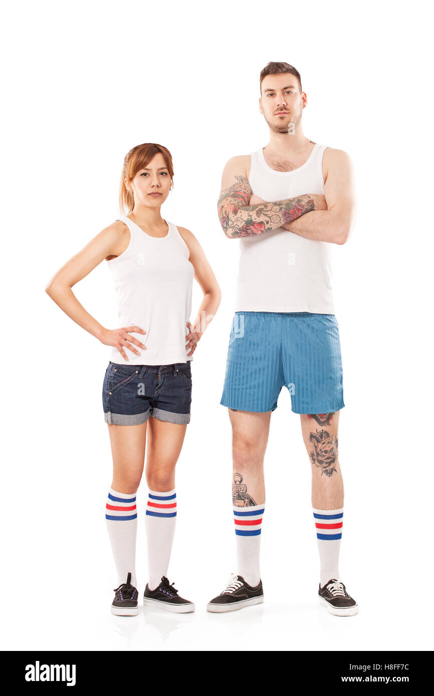 Giovane uomo e donna vestita in abbigliamento sportivo in posa di studio Foto Stock