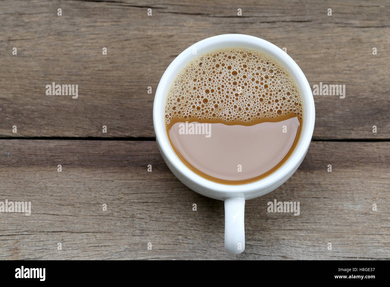 Caffè caldo in un bianco tazza di caffè sul tavolo in legno presso la caffetteria. Foto Stock