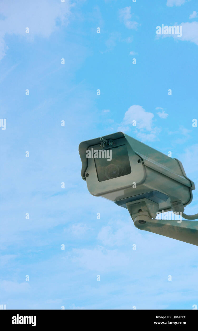 Una telecamera di sicurezza sulla parete contro le nubi Foto Stock
