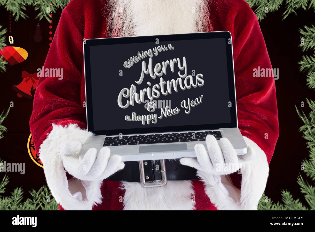 Babbo Natale mostra lap top con auguri di Natale Foto Stock