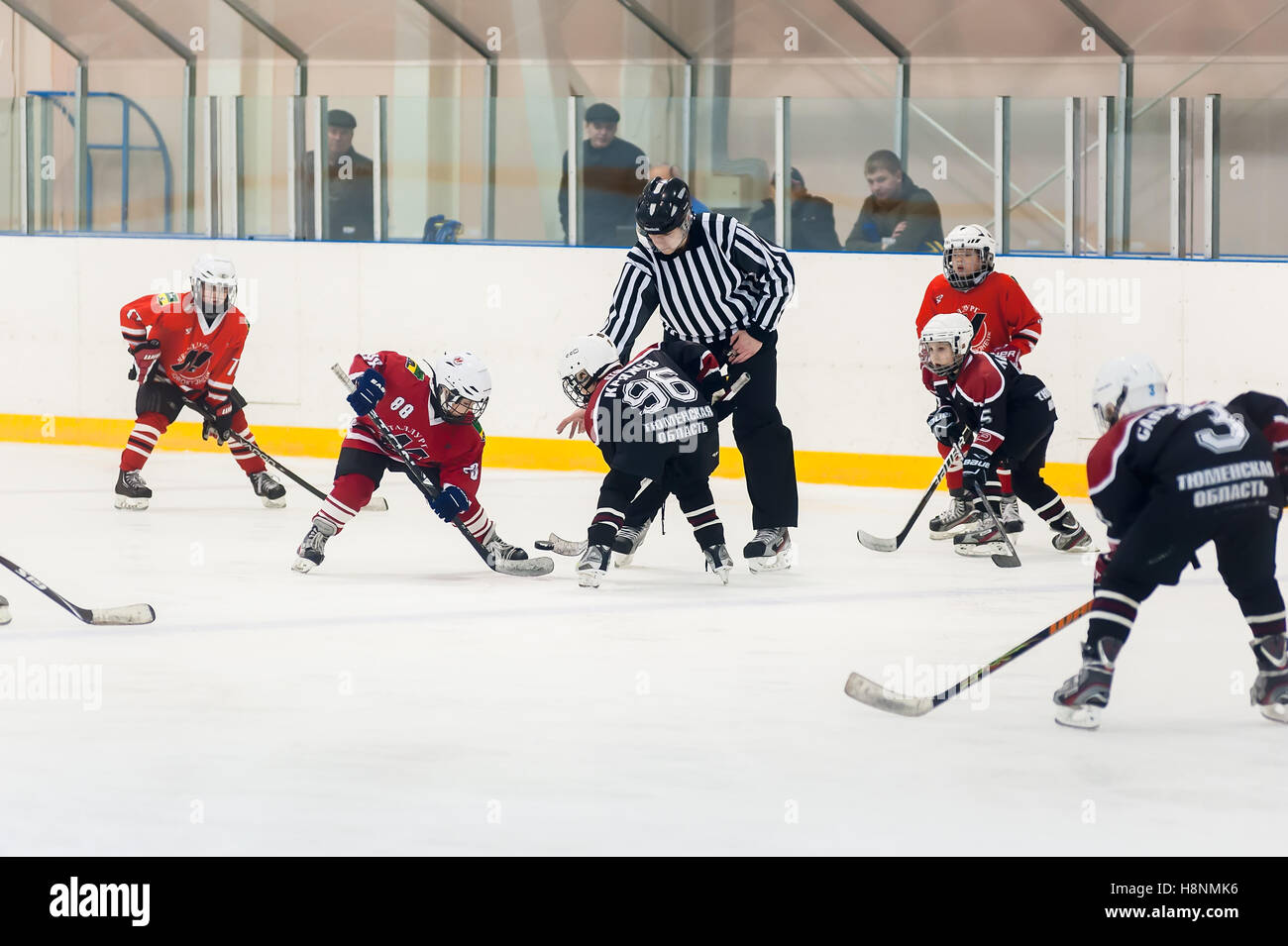 Puck giocando tra giocatori di hockey su ghiaccio squadre Foto Stock