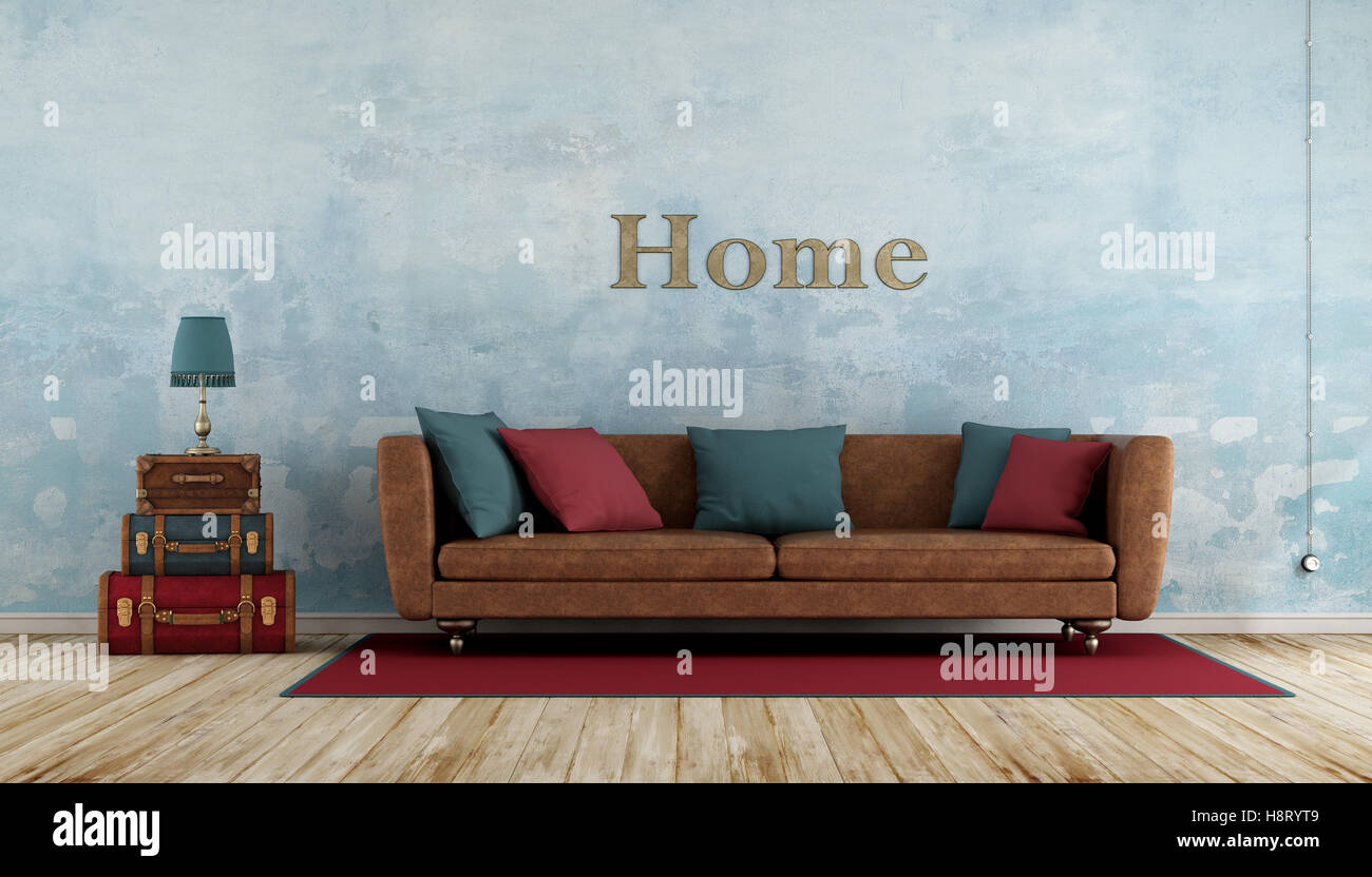 Camera vecchia con coloratissime valigie in pelle,divano ,parete blu e pavimento in legno - 3d rendering Foto Stock