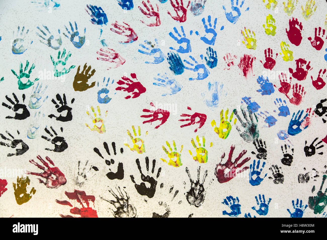 Molte diverse stampe a mano su una parete, colori, piccolo grande, ragazzi, adulti, Foto Stock