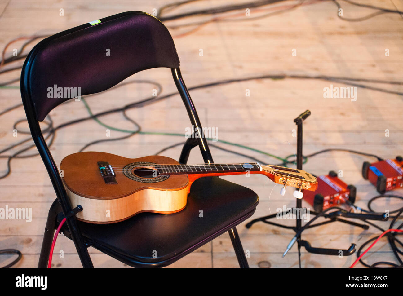 Chitarra acustica seduti su una sedia durante la pausa nel concerto di musica Foto Stock