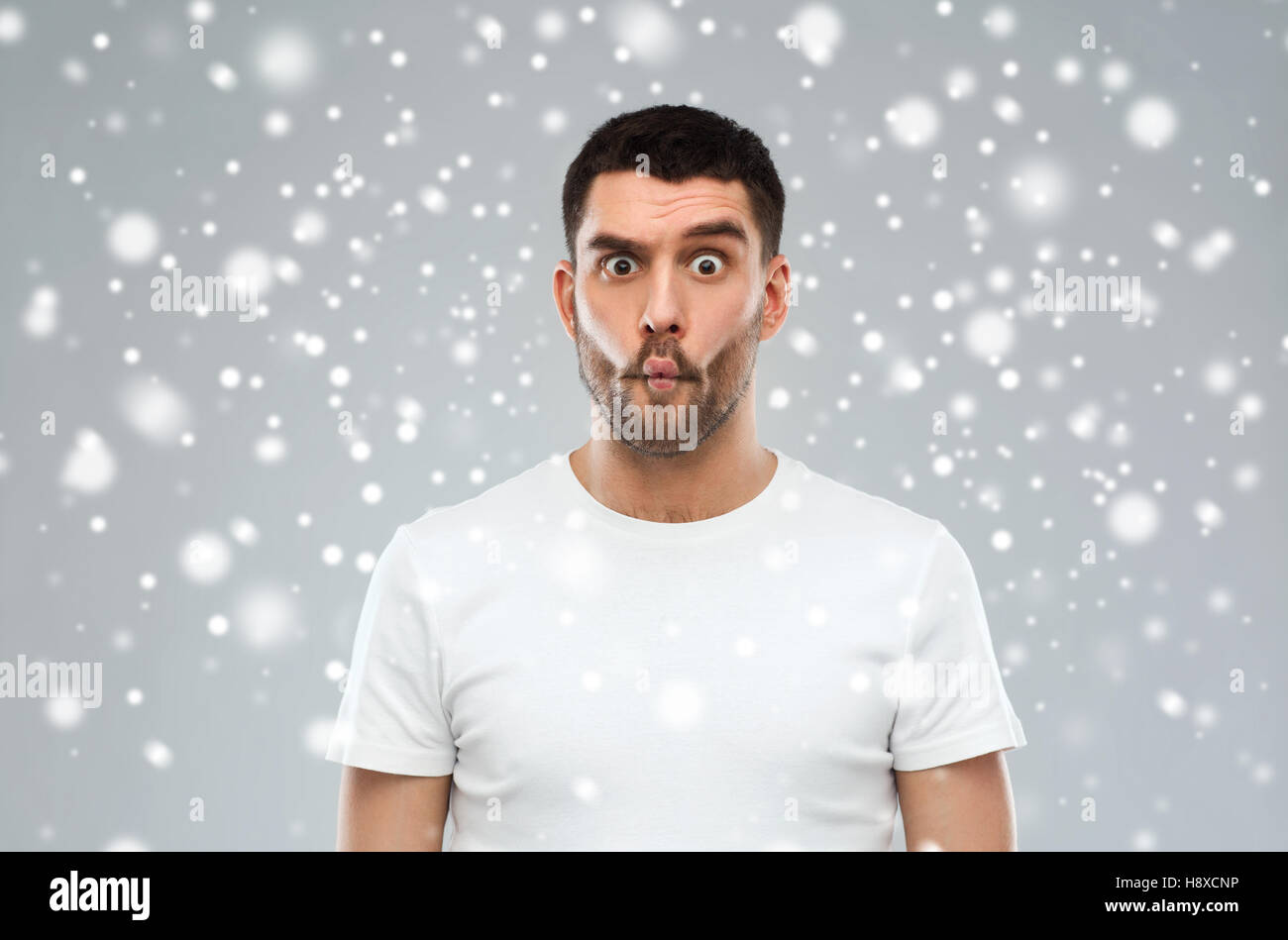 L'uomo con il pesce faccia su sfondo di neve Foto Stock