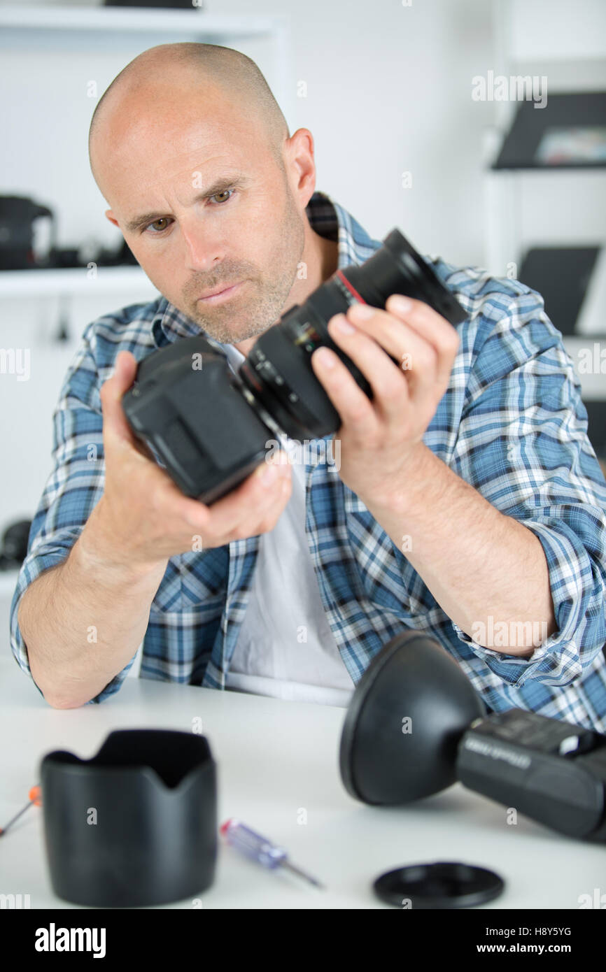 Fotografo professionista man tenere la fotocamera con macro len Foto Stock