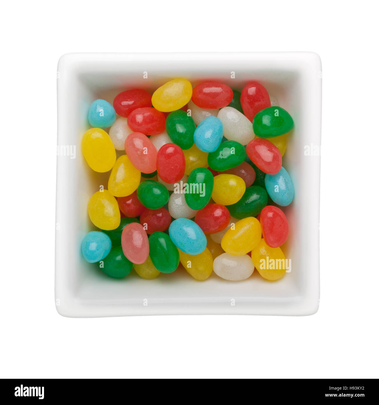 Colorato jelly bean caramelle in un recipiente quadrato isolato su sfondo bianco Foto Stock