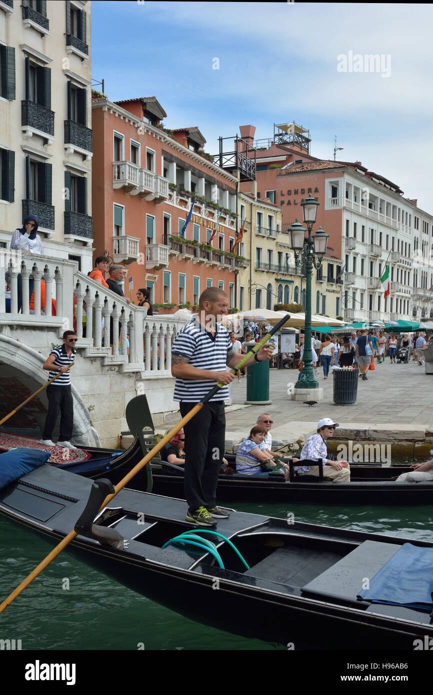 Gondoliere con turisti sul lungomare di Riva degli Schiavoni di Venezia in Italia. Foto Stock