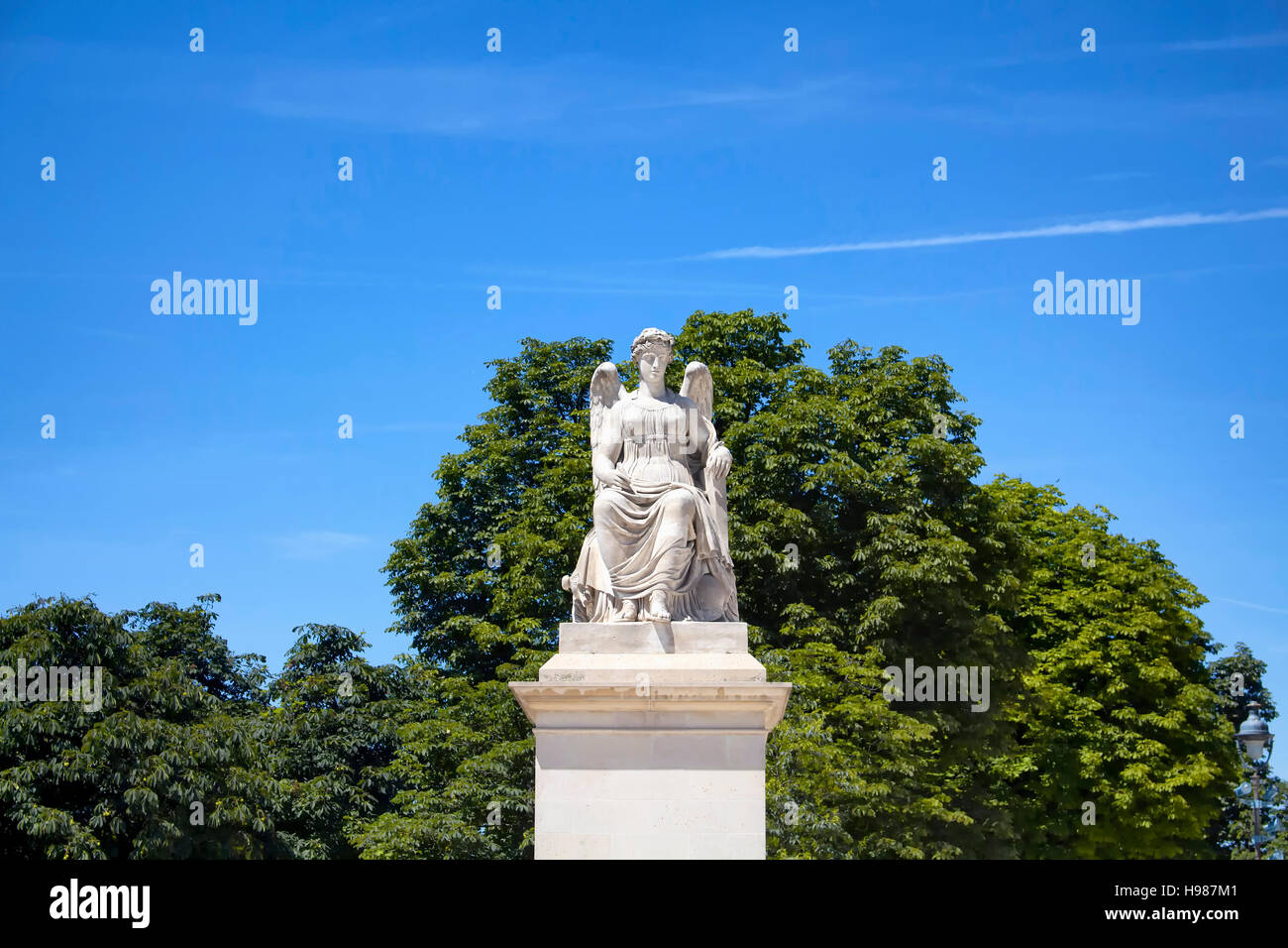 Vista della donna alata statua al Jardin des Tuileries di Parigi. Alberi e cielo blu sono in background. Foto Stock