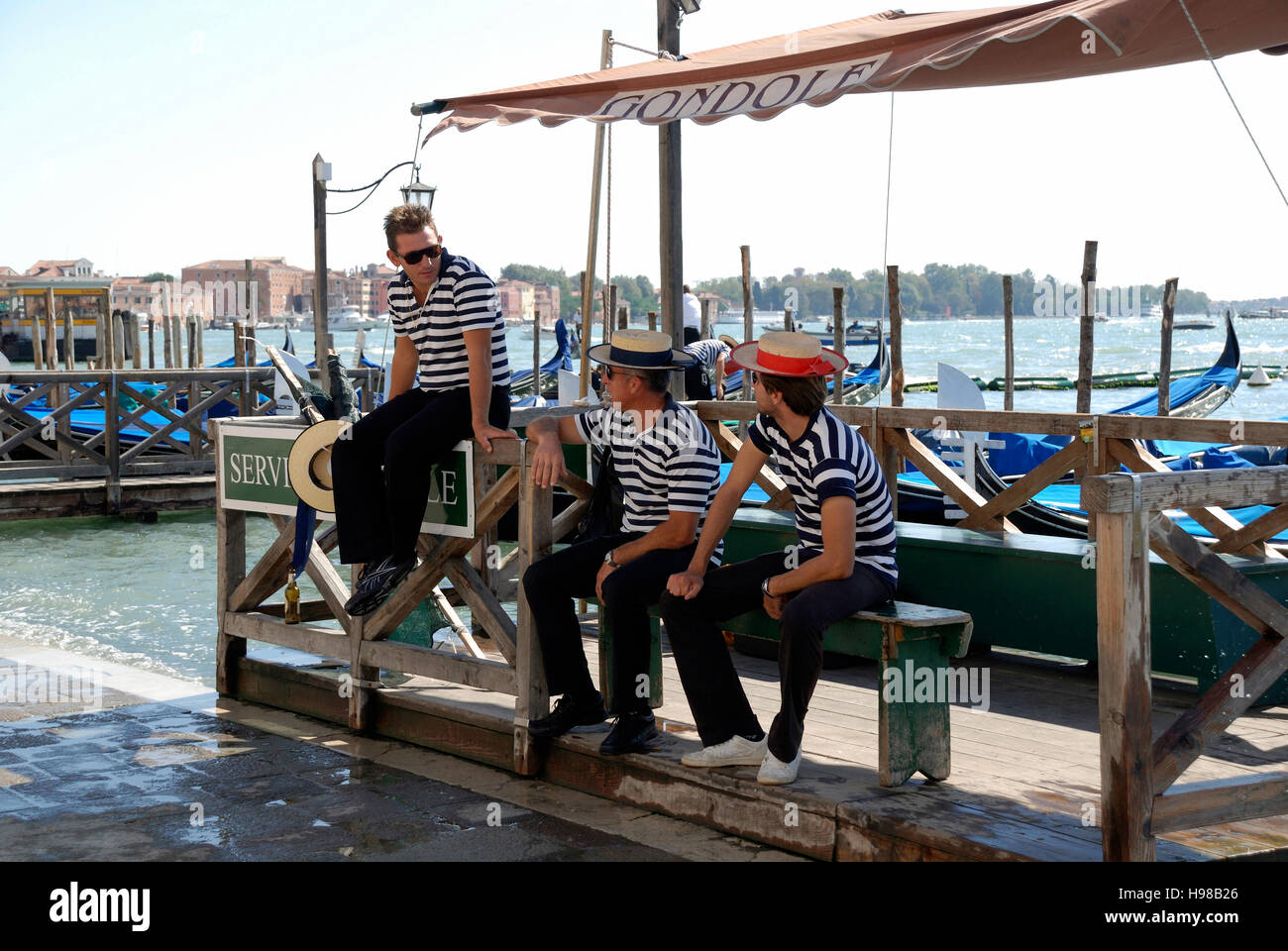 Gondolieri con il tipico copricapo sul Canal Grande di Venezia in Italia. Foto Stock