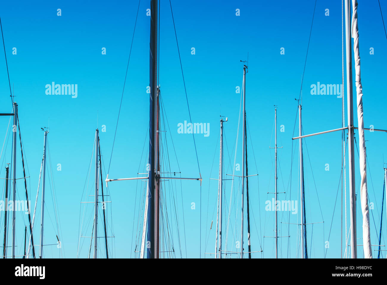 Barca a vela a montanti in porto contro il cielo blu, estate vacanze sfondo astratto Foto Stock