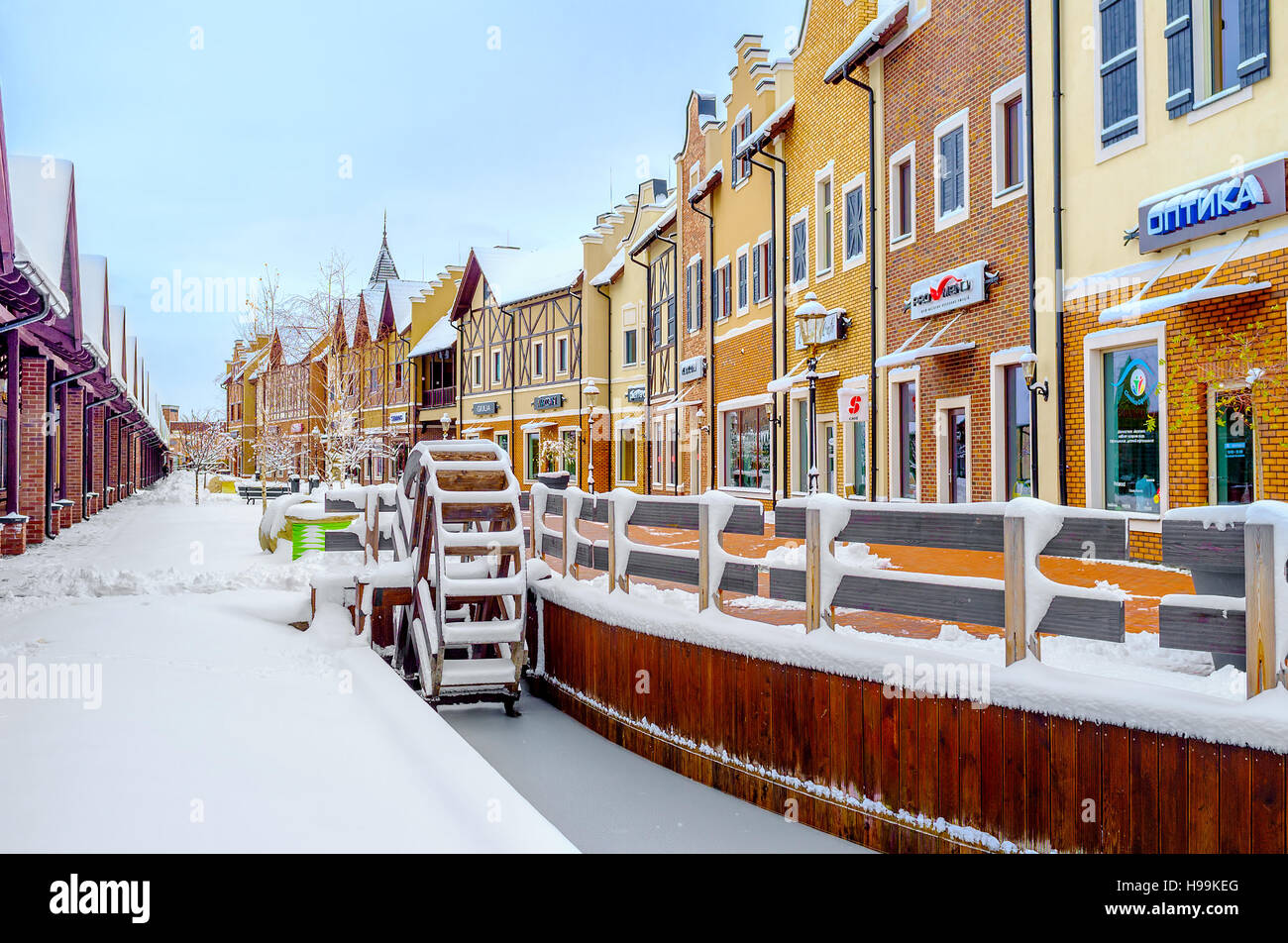 La ruota di acqua di legno in un canale congelati in olandese in stile Revival shopping city è coperto di neve, Kiev Foto Stock
