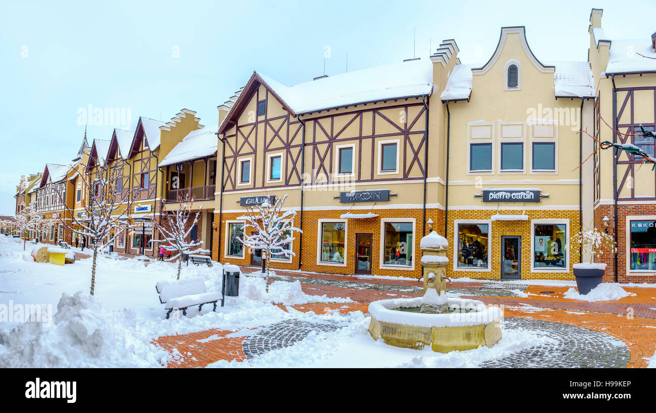 Il piccolo parco con la pietra fontana potabile in stile olandese shopping city ricoperta di neve, Kiev Foto Stock
