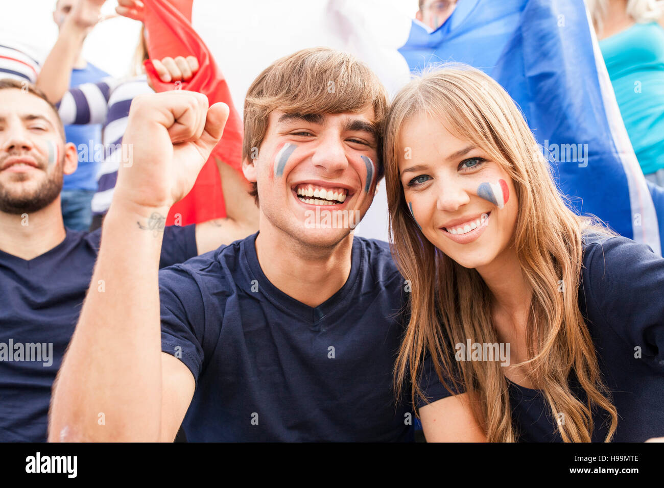 Un gruppo di appassionati di calcio celebrando con bandiera francese Foto Stock