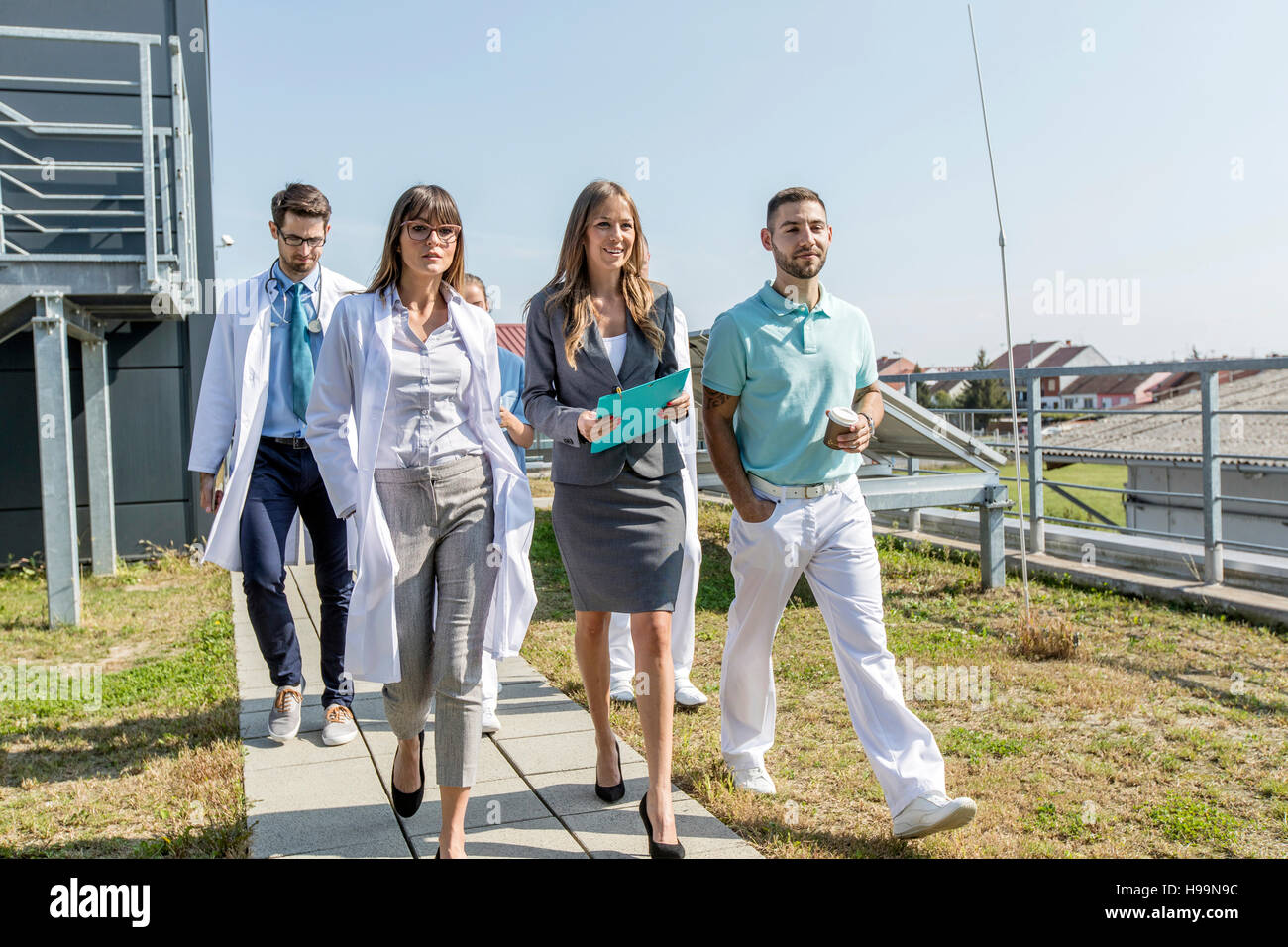 Team di medici e operatori sanitari passeggiate all'aperto Foto Stock