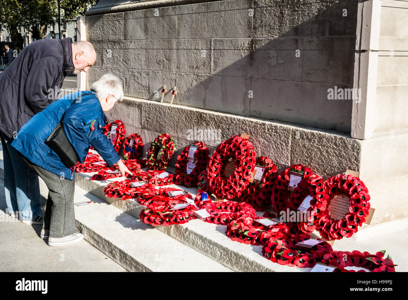 Una coppia di mezza età che paga i loro omaggi al Cenotaph on Whitehall a Londra, Regno Unito Foto Stock