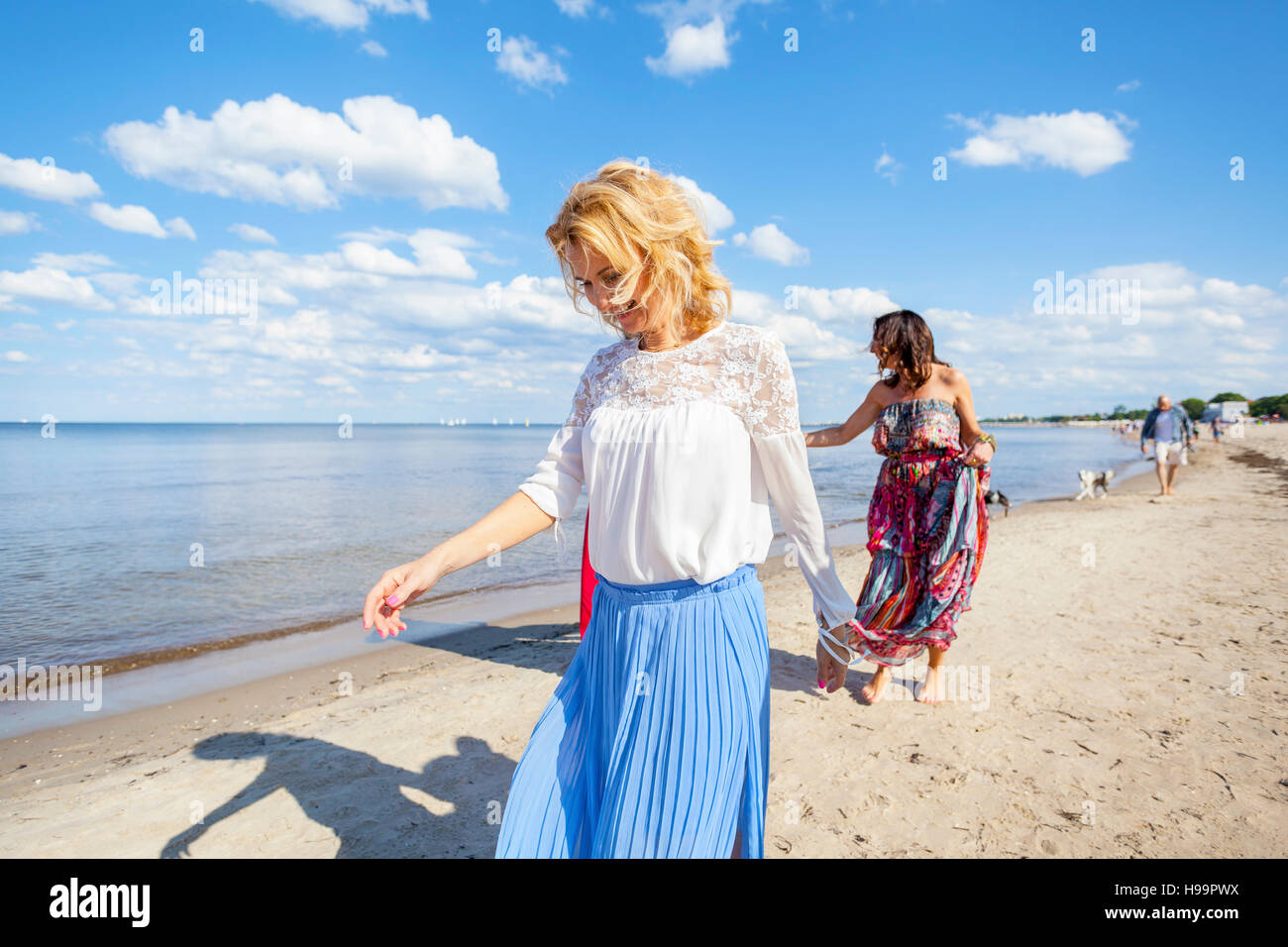 Il gruppo di donne a fare una passeggiata lungo la spiaggia Foto Stock