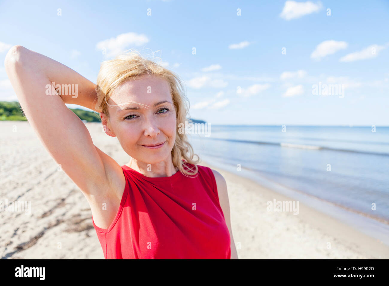 Ritratto di donna con capelli biondi sulla spiaggia Foto Stock
