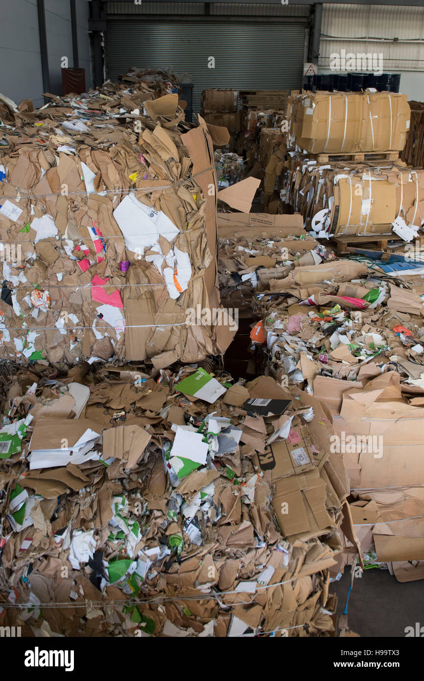 Pile di cartone usato pronto per il riciclo in una fabbrica. Foto Stock