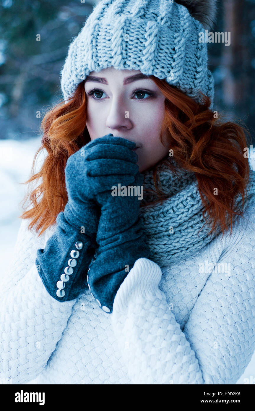 Moda giovane ragazza testa rossa nella foresta di inverno Foto Stock