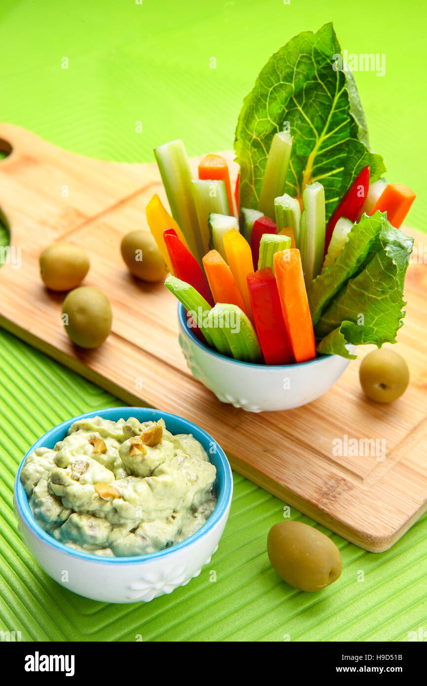 Il sedano e la carota bastoni in vetro, olio d'oliva e yogurt dip Foto Stock