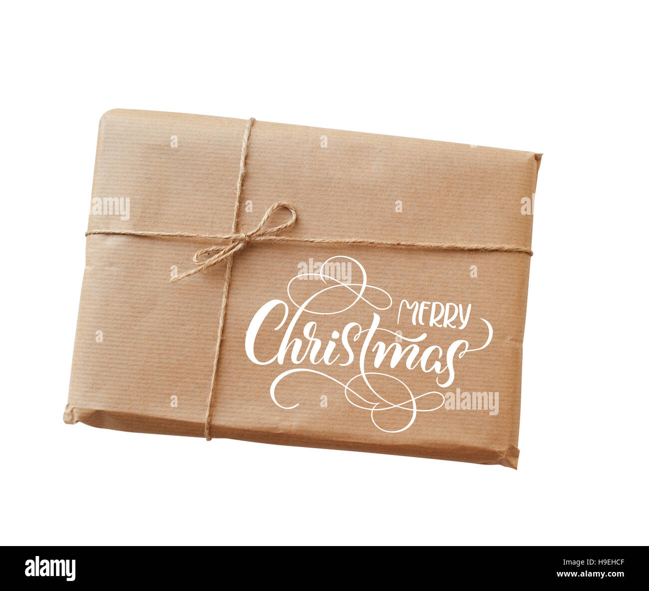 Busta di carta kraft legato con una corda e testo Buon Natale. Calligraphy lettering Foto Stock