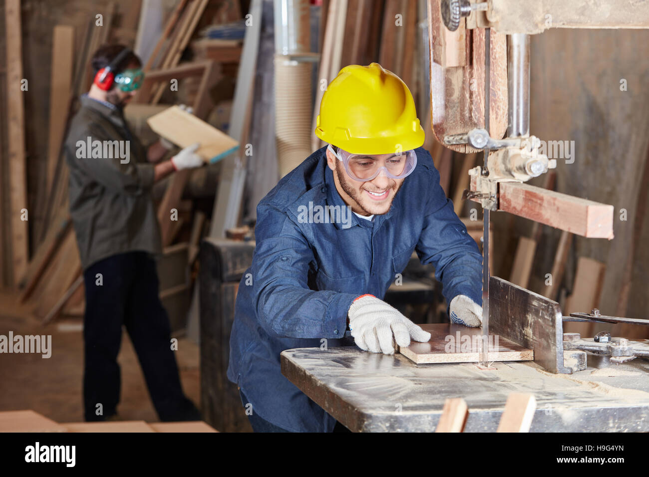 La lavorazione del legno con una sega a nastro al negozio di falegnameria Foto Stock