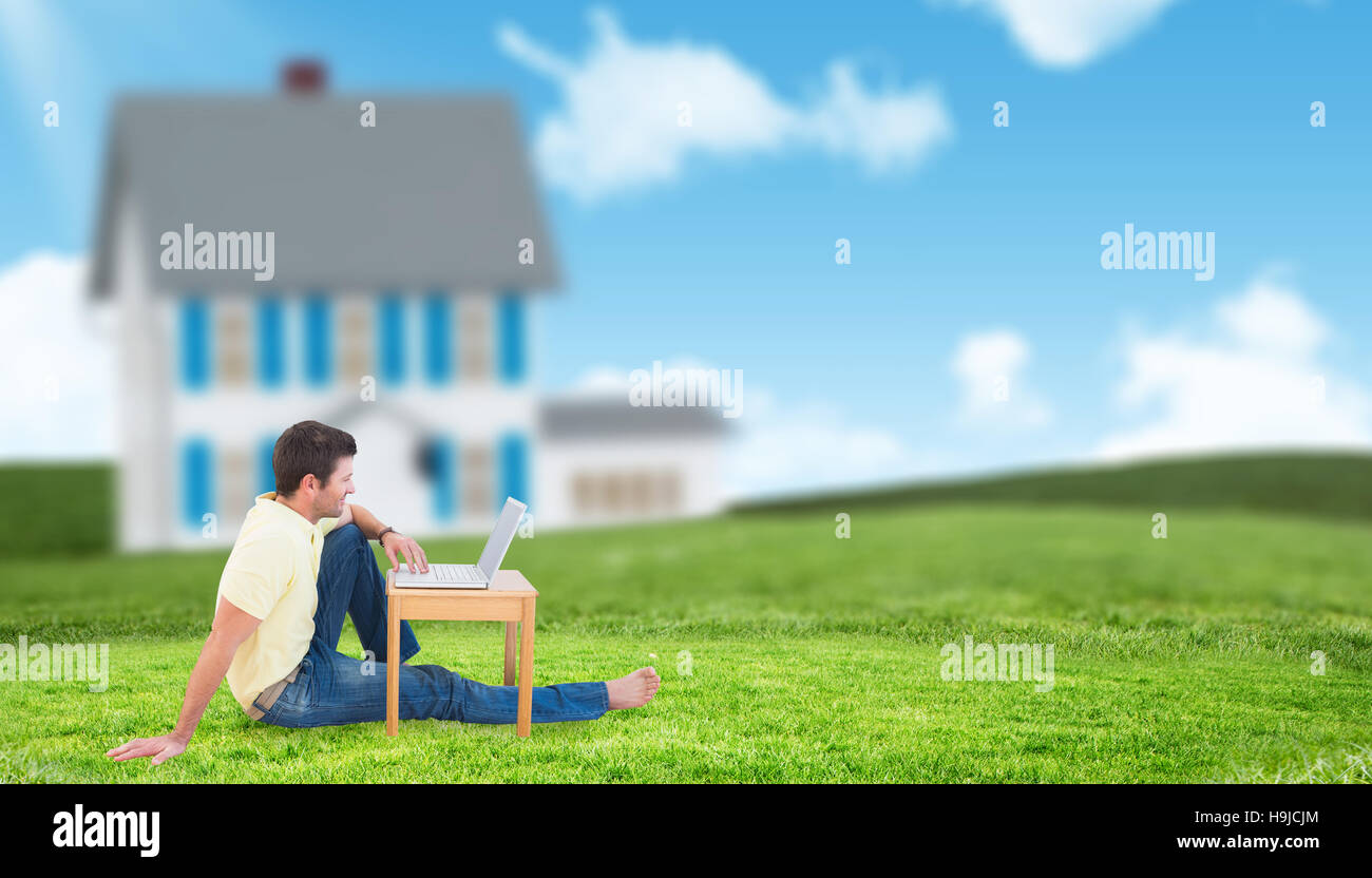 Immagine composita di sorridere uomo che utilizza un notebook Foto Stock